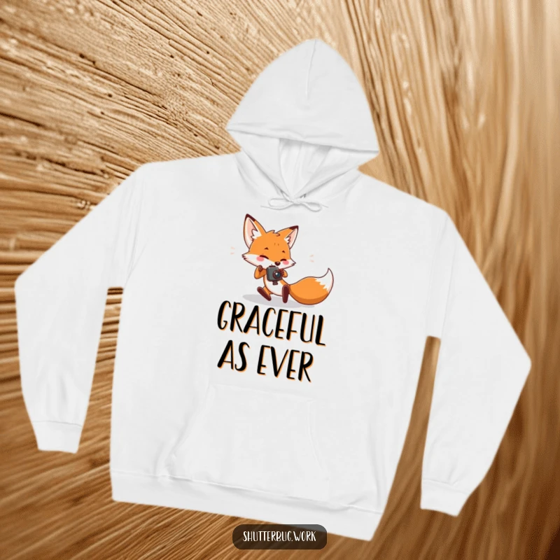 Funny Hoodie featuring a fox character comically falling over while trying to take a picture, providing warmth and humorous relatability for photographers.