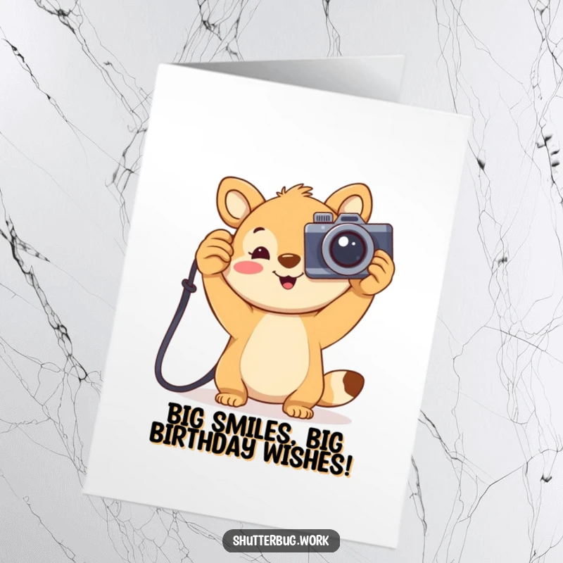 Funny Free Printable Birthday Card: Joyful animal holding a large cartoonish camera high, celebrating a birthday. Downloadable and fun.
